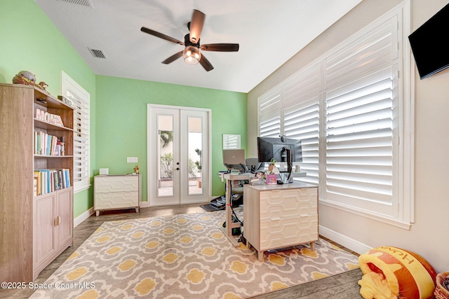 office with visible vents, baseboards, ceiling fan, french doors, and wood finished floors