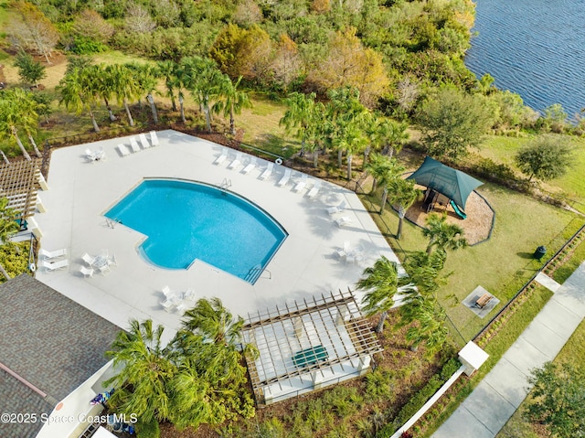 community pool with a patio, a lawn, and a water view