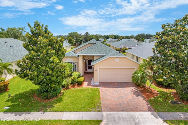 view of front of property with stucco siding, an attached garage, decorative driveway, a shingled roof, and a front lawn