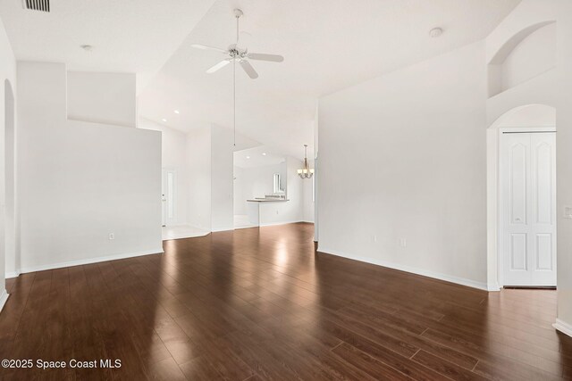 unfurnished living room featuring a ceiling fan, high vaulted ceiling, wood finished floors, a chandelier, and arched walkways