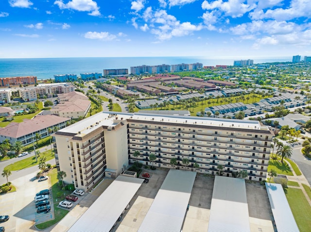 drone / aerial view featuring a view of city and a water view