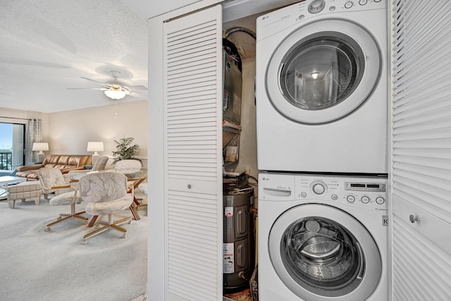 washroom with a textured ceiling, ceiling fan, stacked washer and dryer, carpet floors, and laundry area