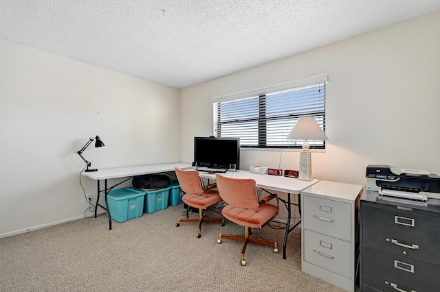 office featuring carpet, baseboards, and a textured ceiling