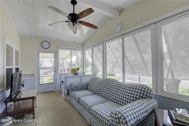 sunroom featuring lofted ceiling with beams, a healthy amount of sunlight, and a ceiling fan