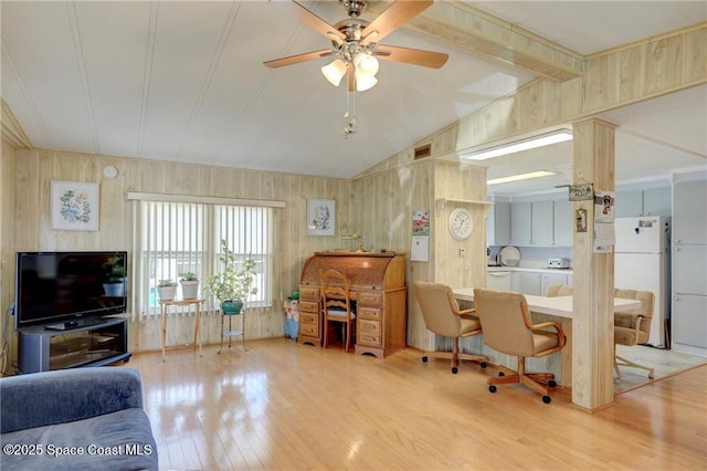 office with wooden walls, ceiling fan, lofted ceiling with beams, and light wood finished floors