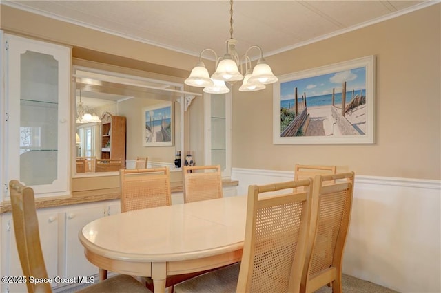 dining room featuring ornamental molding and a notable chandelier