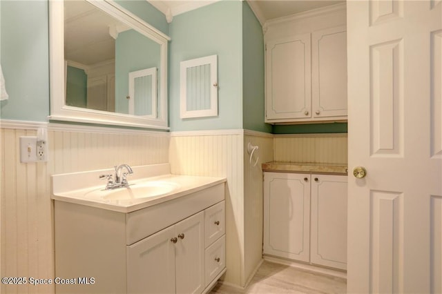 bathroom featuring a wainscoted wall and vanity