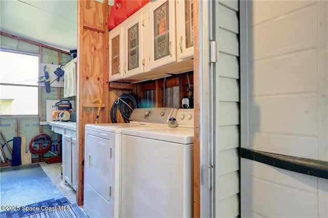 laundry area with washer and dryer and cabinet space