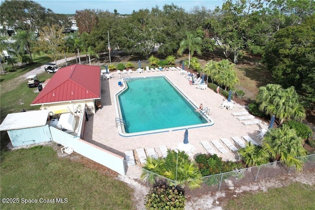 community pool featuring a yard, a patio area, and fence