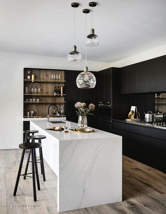 kitchen featuring pendant lighting, an island with sink, light wood-style flooring, modern cabinets, and open shelves