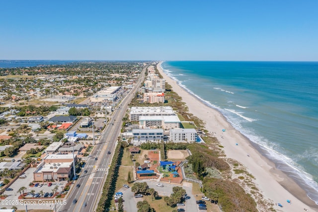 bird's eye view with a water view and a beach view