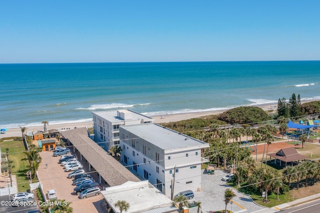 bird's eye view featuring a water view and a beach view