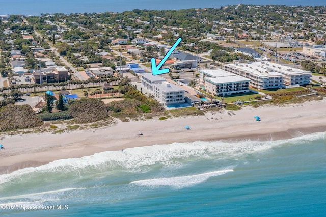 bird's eye view with a water view and a beach view