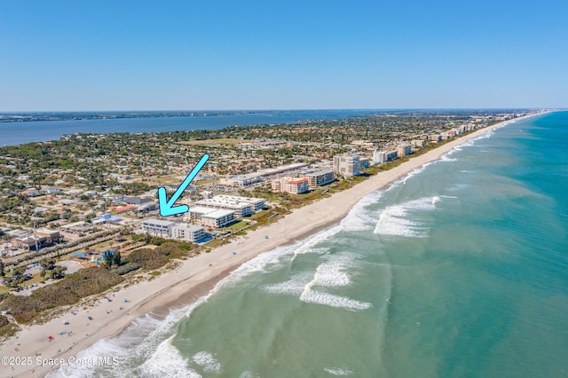 birds eye view of property with a water view, a city view, and a view of the beach