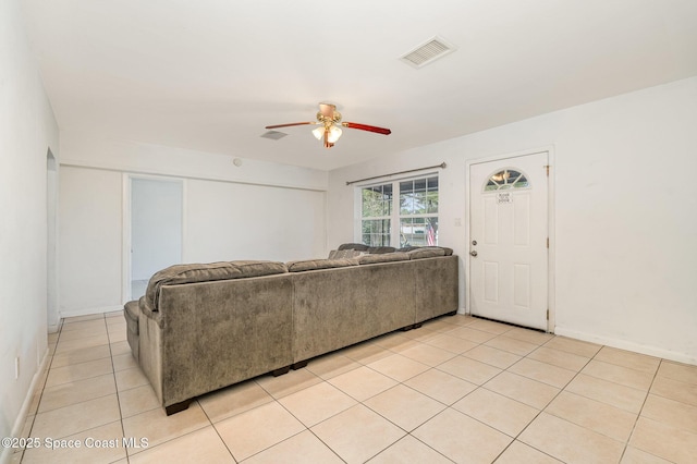 living room with ceiling fan, light tile patterned flooring, visible vents, and baseboards