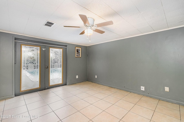 spare room featuring ornamental molding, french doors, visible vents, and a ceiling fan