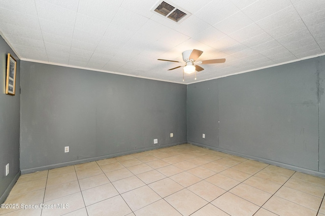 empty room with ornamental molding, visible vents, and a ceiling fan