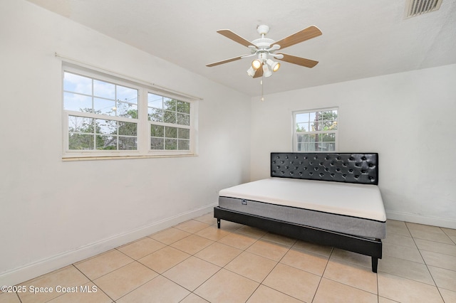 sitting room with light tile patterned floors, a ceiling fan, visible vents, and baseboards