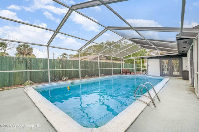 view of pool with a patio area, a fenced backyard, glass enclosure, and a fenced in pool