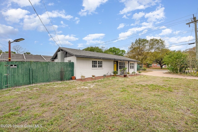 view of front of house featuring fence and a front yard