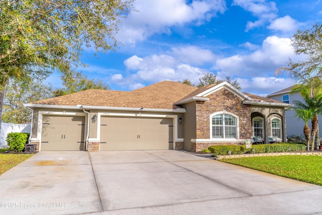 view of front of property with stone siding, driveway, an attached garage, and stucco siding