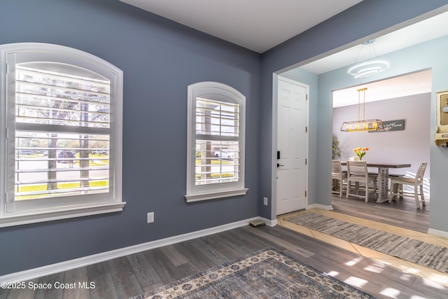 entrance foyer with baseboards and wood finished floors