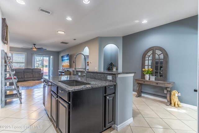 kitchen with open floor plan, visible vents, a sink, and light tile patterned floors