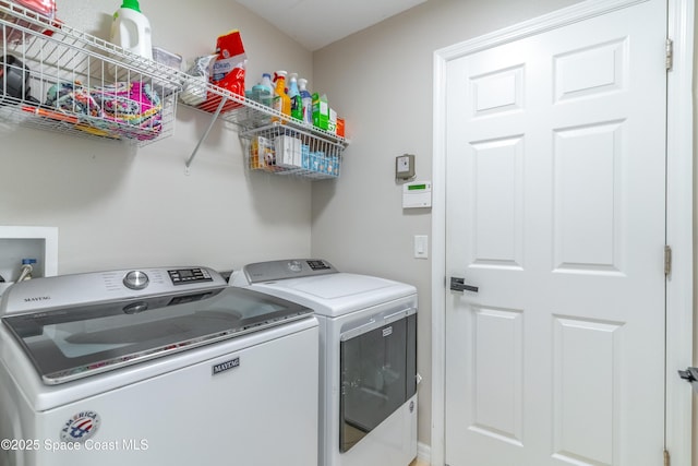 laundry area featuring washing machine and dryer and laundry area