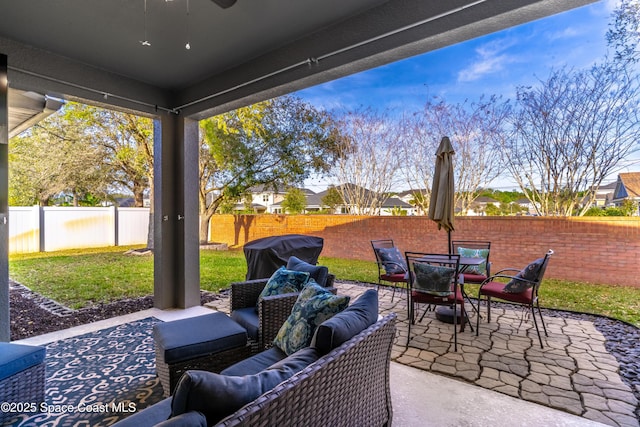 view of patio / terrace featuring an outdoor hangout area, outdoor dining space, area for grilling, and a fenced backyard