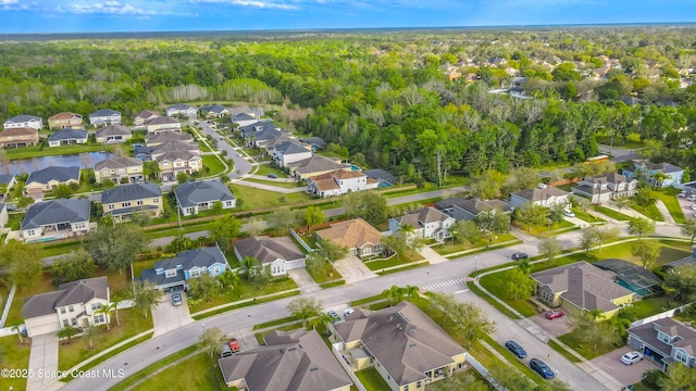 drone / aerial view with a residential view and a view of trees