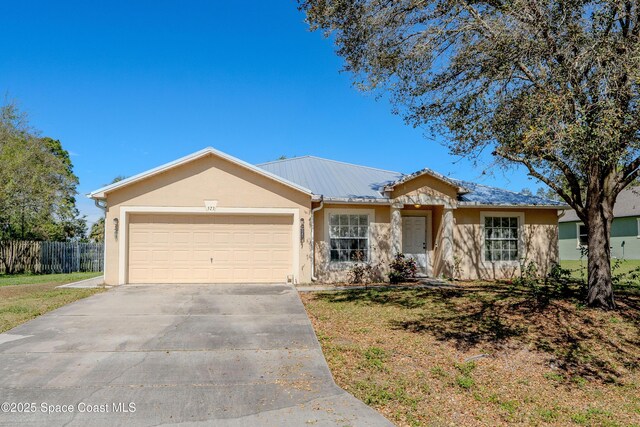 ranch-style home with stucco siding, concrete driveway, fence, a garage, and a front lawn