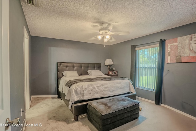 carpeted bedroom featuring access to exterior, visible vents, a ceiling fan, a textured ceiling, and baseboards