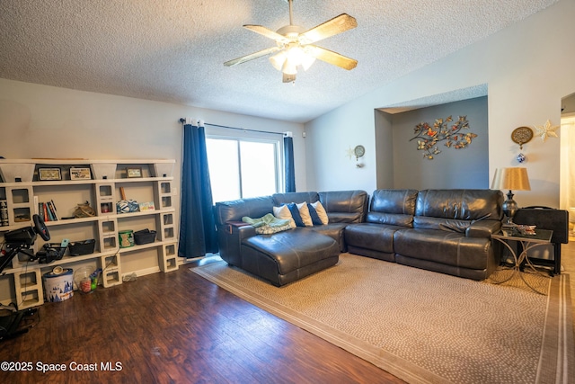 living room featuring a textured ceiling, wood finished floors, a ceiling fan, and lofted ceiling