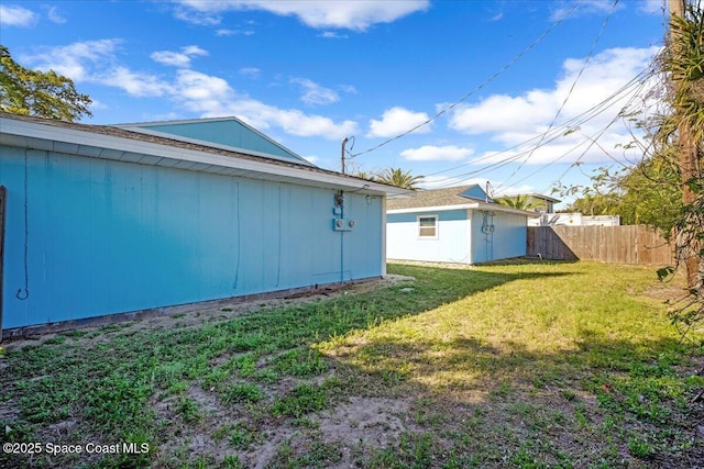 view of yard with an outdoor structure and fence