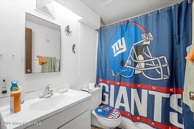 bathroom with vanity, a shower with shower curtain, and toilet