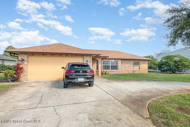 ranch-style home featuring driveway, an attached garage, a front yard, and brick siding