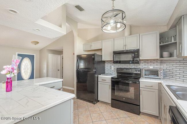 kitchen featuring visible vents, decorative backsplash, light tile patterned flooring, vaulted ceiling, and black appliances