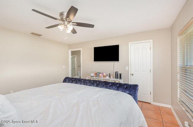 bedroom featuring a ceiling fan, visible vents, baseboards, and light tile patterned floors