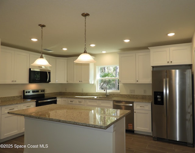 kitchen featuring white cabinets, a kitchen island, and stainless steel appliances