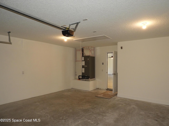 garage with a garage door opener and heating unit