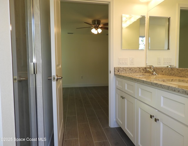 bathroom with ceiling fan, baseboards, vanity, and wood tiled floor