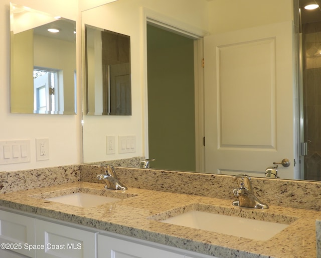 bathroom featuring a sink and double vanity