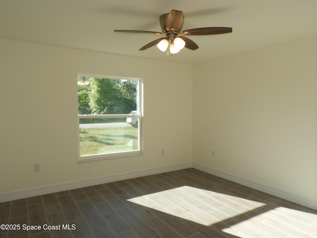 spare room with wood tiled floor, baseboards, and a ceiling fan