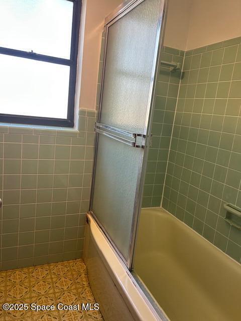 full bathroom with shower / bath combination with glass door