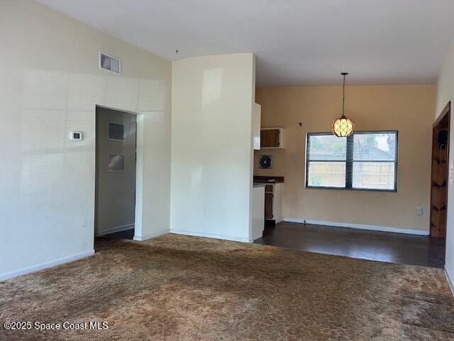 carpeted spare room with baseboards and visible vents