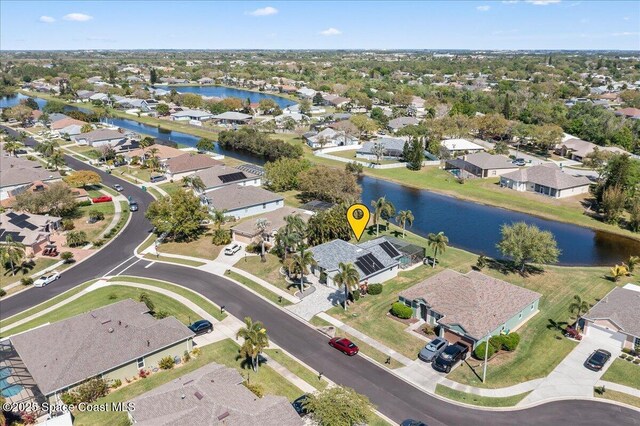 drone / aerial view with a residential view and a water view