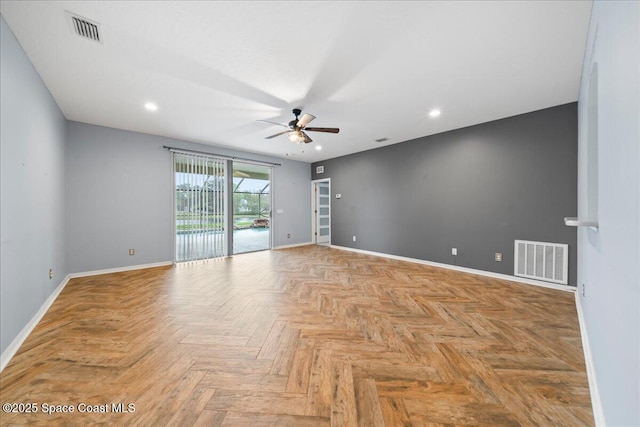 spare room with visible vents, baseboards, and ceiling fan