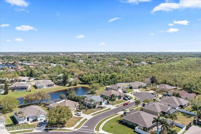 drone / aerial view with a residential view and a water view