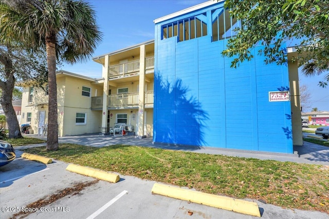 view of building exterior with uncovered parking