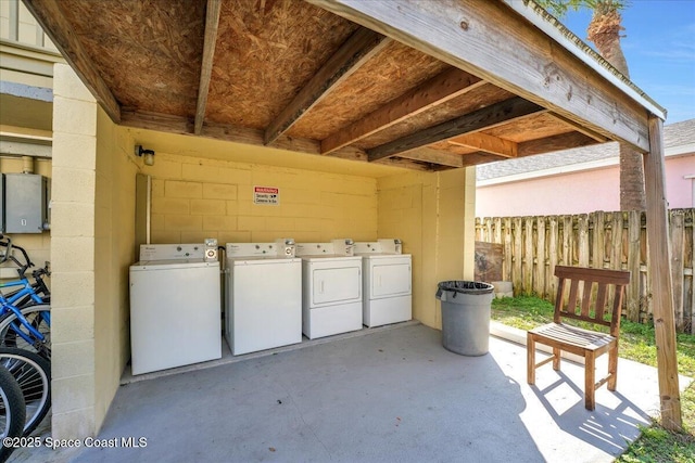 view of patio with washer / dryer and fence